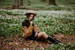 Side view of stylish sensual woman relaxing in blooming forest