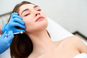 Woman relaxing getting dermal filler injections in Dallas, TX