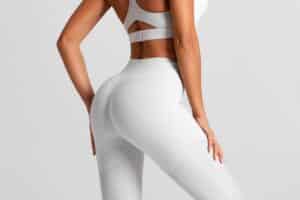 Woman in white workout wear with full, round butt from non-surgical BBL in Dallas, TX