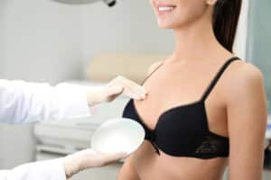 Woman looking at breast implants with surgeon in Dallas, TX