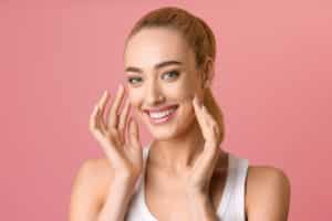 Woman smiling looking youthful and fresh from facial fat grafting in Dallas, TX